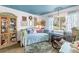 Bright room with blue ceiling, daybed with throw pillows and window with sheer curtains at 2475 Bay Berry Dr, Clearwater, FL 33763