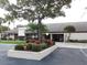 Community center showcasing manicured landscaping and mature oak trees in front of the building at 2475 Bay Berry Dr, Clearwater, FL 33763