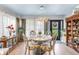 Formal dining room with chandelier, large windows, and access to the front entry at 2475 Bay Berry Dr, Clearwater, FL 33763