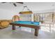 Bright game room with pool table under decorative light fixture and bright windows at 2475 Bay Berry Dr, Clearwater, FL 33763