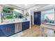 Updated kitchen with white countertops, stainless steel appliances, and custom blue cabinets at 2475 Bay Berry Dr, Clearwater, FL 33763