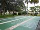 Well-maintained shuffleboard courts lined by mature trees and comfortable seating at 2475 Bay Berry Dr, Clearwater, FL 33763