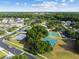 High aerial view of a community featuring a playground, pool, and basketball courts at 25521 Bruford Blvd, Land O Lakes, FL 34639