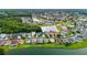 Aerial view showcasing homes situated around a lake in a suburban neighborhood at 25521 Bruford Blvd, Land O Lakes, FL 34639