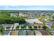 Expansive aerial view of a residential neighborhood with a scenic lake and lush green trees at 25521 Bruford Blvd, Land O Lakes, FL 34639
