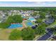 A sweeping aerial shot capturing the community's pool, playground, and basketball court at 25521 Bruford Blvd, Land O Lakes, FL 34639