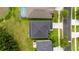 Aerial view of a home showcasing its roof, landscaping, pool, and surrounding neighborhood at 25521 Bruford Blvd, Land O Lakes, FL 34639