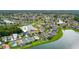 Aerial view showcasing lakeside homes in a community, complete with serene water views and lush greenery at 25521 Bruford Blvd, Land O Lakes, FL 34639