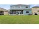 Two-story home featuring a screened-in lanai and large backyard at 25521 Bruford Blvd, Land O Lakes, FL 34639