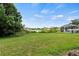 Spacious backyard overlooking a tranquil pond and screened-in pool area at 25521 Bruford Blvd, Land O Lakes, FL 34639