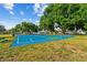 Community basketball court with mature trees for shaded recreation on a sunny day at 25521 Bruford Blvd, Land O Lakes, FL 34639