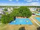 Aerial view of community's basketball court surrounded by trees and residential properties at 25521 Bruford Blvd, Land O Lakes, FL 34639