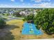 The blue basketball court offers outdoor recreation in this community, surrounded by lush trees at 25521 Bruford Blvd, Land O Lakes, FL 34639