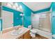 A bathroom featuring a turquoise colored wall, glass enclosed shower, and a single sink vanity at 25521 Bruford Blvd, Land O Lakes, FL 34639