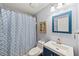 The bathroom features neutral walls, a patterned shower curtain, and a vanity with storage at 25521 Bruford Blvd, Land O Lakes, FL 34639