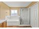 Bathroom featuring a bathtub, glass shower enclosure, and spacious vanity at 25521 Bruford Blvd, Land O Lakes, FL 34639