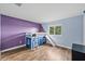 Bright bedroom featuring a unique bunk bed with a slide and wood-look flooring at 25521 Bruford Blvd, Land O Lakes, FL 34639