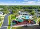 Overhead shot displays a community pool, playground, and well-manicured lawns, enhancing the appeal of this vibrant neighborhood at 25521 Bruford Blvd, Land O Lakes, FL 34639