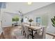The dining room features neutral walls, a decorative rug, a ceiling fan, and natural light at 25521 Bruford Blvd, Land O Lakes, FL 34639