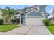 Well-maintained two-story home with a spacious driveway and attached two-car garage at 25521 Bruford Blvd, Land O Lakes, FL 34639