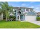 Beautiful two-story home with a well-manicured lawn and attached two-car garage at 25521 Bruford Blvd, Land O Lakes, FL 34639