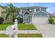 Charming two-story home with a manicured lawn and a two-car garage, perfect for Gathering living at 25521 Bruford Blvd, Land O Lakes, FL 34639