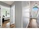 The hallway features hardwood floors and leads to the bedroom, staircase, and entryway at 25521 Bruford Blvd, Land O Lakes, FL 34639