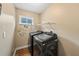 Functional laundry room with modern washer and dryer, plus an ironing board at 25521 Bruford Blvd, Land O Lakes, FL 34639