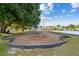 Community playground with swings and a soft ground cover surrounded by mature landscaping at 25521 Bruford Blvd, Land O Lakes, FL 34639