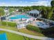 A beautiful swimming pool area featuring a spa, lounge chairs, and patio umbrellas at 25521 Bruford Blvd, Land O Lakes, FL 34639
