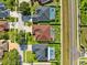 An aerial view showcases a neighborhood with fenced-in backyards and swimming pools with screened enclosures at 2814 Duncan Tree Cir, Valrico, FL 33594