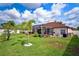 Beautiful backyard with a screened-in pool, a manicured lawn, and well-maintained landscaping, perfect for outdoor living at 2814 Duncan Tree Cir, Valrico, FL 33594