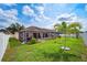 Well-maintained backyard with screened-in pool area, tropical landscaping, and ample green space at 2814 Duncan Tree Cir, Valrico, FL 33594