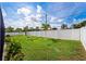 The expansive backyard features vibrant landscaping, lush green grass and an updated white vinyl fence at 2814 Duncan Tree Cir, Valrico, FL 33594