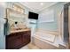 Bathroom features a garden tub, and shower with glass doors, a large framed mirror and granite countertops at 2814 Duncan Tree Cir, Valrico, FL 33594