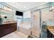 Bathroom features a garden tub, and shower with glass doors and granite countertops at 2814 Duncan Tree Cir, Valrico, FL 33594