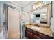 Bathroom with a large framed mirror, granite countertops, and tiled shower with glass door at 2814 Duncan Tree Cir, Valrico, FL 33594