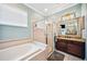 Bathroom featuring a large garden tub and glass shower, and granite countertops at 2814 Duncan Tree Cir, Valrico, FL 33594