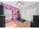 This bedroom features purple patterned accent wall, window, ceiling fan and closet at 2814 Duncan Tree Cir, Valrico, FL 33594