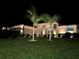 Single-story home featuring a well-manicured lawn and an attached three-car garage at night at 2814 Duncan Tree Cir, Valrico, FL 33594