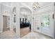 Elegant foyer with arched entrances, tile flooring and clear view of the bar area at 2814 Duncan Tree Cir, Valrico, FL 33594