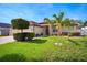 Beautiful single-story home with a lush lawn, mature landscaping, and a three-car garage at 2814 Duncan Tree Cir, Valrico, FL 33594