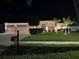 Charming home with lush lawn, manicured hedges, and three-car garage, illuminated at night at 2814 Duncan Tree Cir, Valrico, FL 33594