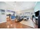 Open-concept living room featuring wood floors, modern furnishings, and sliding glass doors to outdoor area at 2814 Duncan Tree Cir, Valrico, FL 33594
