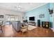 Bright living room featuring a ceiling fan, wood floors, and sliding glass doors leading to outdoor pool at 2814 Duncan Tree Cir, Valrico, FL 33594
