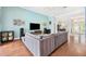 Open-concept living room with wood floors, neutral decor, and view to dining area and front entry at 2814 Duncan Tree Cir, Valrico, FL 33594