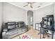 Living room with wood flooring, leather sofa, and workspace at 2814 Duncan Tree Cir, Valrico, FL 33594