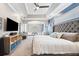 The main bedroom features a ceiling fan, tray ceiling, carpet, tufted headboard, and neutral tones at 2814 Duncan Tree Cir, Valrico, FL 33594