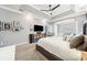 The spacious main bedroom has a ceiling fan, tray ceiling, carpeting, and a seating area at 2814 Duncan Tree Cir, Valrico, FL 33594