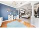 The main bedroom has wood floors, a large rug, columns, blue walls, and neutral decor at 2814 Duncan Tree Cir, Valrico, FL 33594